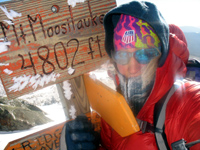 Hugging the peak marker of Mt. Moosilauke